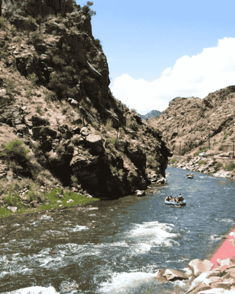 Visitors white water rafting on the Arkansas River in the Royal Gorge region, seen from the train ride